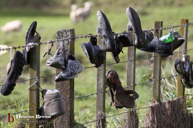 Old shoes on a farmer's fence